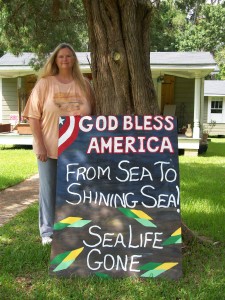 Artist, Lori Bosarge, with one of her signs
