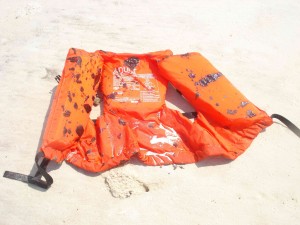 Oiled life jacket on beach